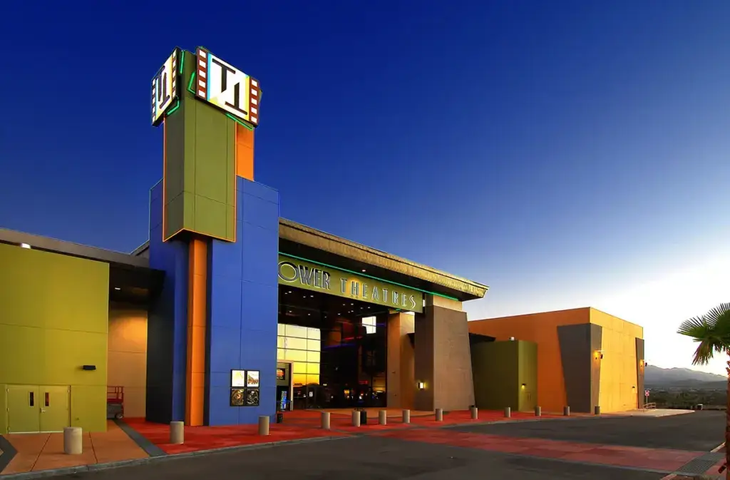 The exterior of a theater with a large tower next to the entrance designed by Seaver Franks architects